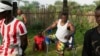 FILE - Farming trainees who lost limbs during Sierra Leone's 1991-2002 civil war do warmup exercises before starting their day at the Farming on Crutches initiative in Freetown, Sierra Leone, Sept. 25, 2024. 