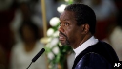 FILE - The Reverend Norvel Goff speaks during a prayer service at the Emanuel A.M.E. Church in Charleston, S.C., four days after a mass shooting that claimed the lives of it's pastor and eight others, June 21, 2015.