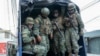 FILE - Soldiers patrol the perimeter of Inca prison during a state of emergency in Quito, Ecuador, Jan. 9, 2024, in the wake of the apparent escape of a powerful gang leader from prison. 