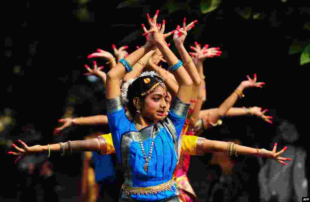 Indian schoolgirls participate in a traditional dance to commemorate 124th birth anniversary of the late first Prime Minister Jawaharlal Nehru at his ancestral home, Anand Bhawan, in Allahabad. 