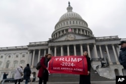 Supporters of President-elect Donald Trump instrumentality     pictures arsenic  they observe  extracurricular  of the U.S. Capitol successful  Washington, Jan. 19, 2025.