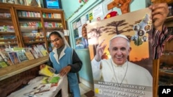 A nun shops in a store offering Pope paraphernalia in Antananarivo, Mozambique, Sept. 3, 2019.