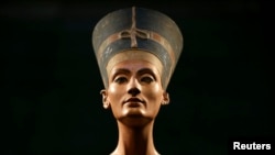 FILE - The Nefertiti bust is pictured during a press preview of the exhibition 'In The Light Of Amarna' at the Neues Museum in Berlin, Germany, due to the 100th anniversary of the discovery of the famous sculpture of the ancient Egyptian queen Nefertiti. 