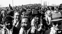 Martin Luther King, Jr. and other civil rights activists during a five day, 50 mile march to Alabama's capital, Montgomery, to protest unfair voting laws