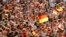 FILE - The June 26, 2011 file photo shows soccer fans waving German flags during the group A match between Germany and Canada at the Women’s Soccer World Cup in Berlin, Germany. 