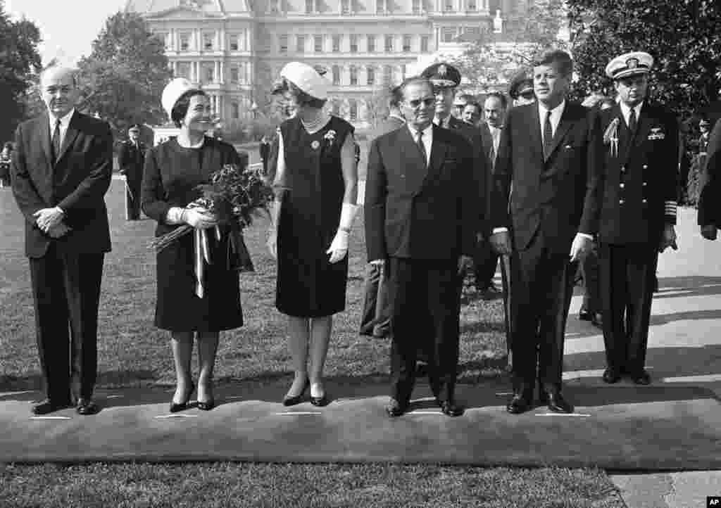 President John F. Kennedy and President Josip Broz Tito of Yugoslavia pose at the White House as Eunice Shriver, Kennedy’s sister, chats with Tito's wife Jovanka, Oct. 17, 1963 in Washington. (AP Photo)