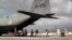 Evacuees leaving the destruction of Hurricane Irma board a C-130 Hercules transport aircraft of the Royal Netherlands Air Force at St. Martin airport September 10, 2017. (Netherlands Ministry of Defense via REUTERS) 