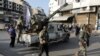 Fighters of the ruling Syrian body patrol after dissent surfaced in the city of Homs