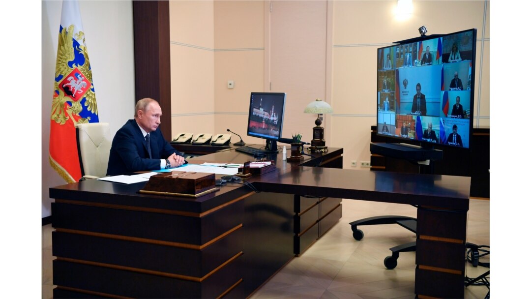 Russian President Vladimir Putin attends a cabinet meeting at the Novo-Ogaryovo residence outside Moscow, Aug. 11, 2020. Putin says that a coronavirus vaccine developed in the country has been registered for use.
