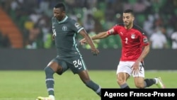 FILE — Nigeria's Umar Sadiq, left, dribbles the ball past an Egyptian player during the African Cup of Nations Group D soccer match in Garoua, Cameroon, Tuesday, Jan. 11, 2022. 