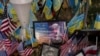 The memorial plate for Tatyana Millard, an American volunteer, is seen among Ukrainian and U.S. flags placed in honor of fallen servicemen in central Kyiv, Ukraine, Nov. 5, 2024.