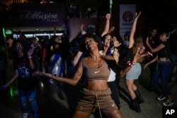 Karla Pina Costa dances with other youths to K-pop at a cultural house in Havana, Cuba, Sept. 7, 2024.