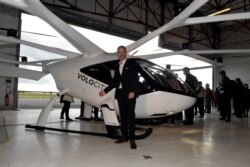 Florian Reuter, CEO of German start-up Volocopter GmbH poses in front of a Volocopter unmanned air taxi transport presented at the Pontoise airport in Cormeilles-en-Vexin, Sept. 30, 2020.