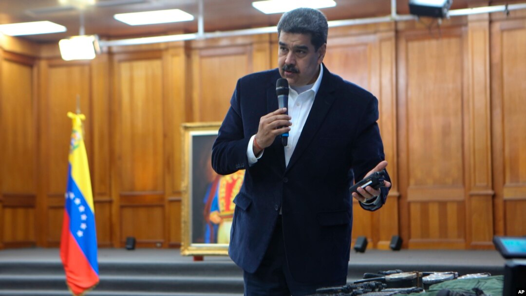 This photo released by the Venezuelan Miraflores presidential press office shows President Nicolas Maduro speaking over military equipment that he says was seized during an incursion into Venezuela in Caracas on May 4, 2020.