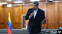 This photo released by the Venezuelan Miraflores presidential press office shows President Nicolas Maduro speaking over military equipment that he says was seized during an incursion into Venezuela in Caracas on May 4, 2020.