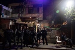 Israeli police stand guard in front of a Palestinian home occupied by settlers during a protest ahead of a court verdict that may forcibly evict Palestinian families from their homes, in the Sheikh Jarrah neighborhood of East Jerusalem, May 5, 2021.