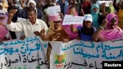 FILE - Mauritanian anti-slavery protesters march to demand the liberation of imprisoned abolitionist leader Biram Ould Abeid in Nouakchott, May 26, 2012.