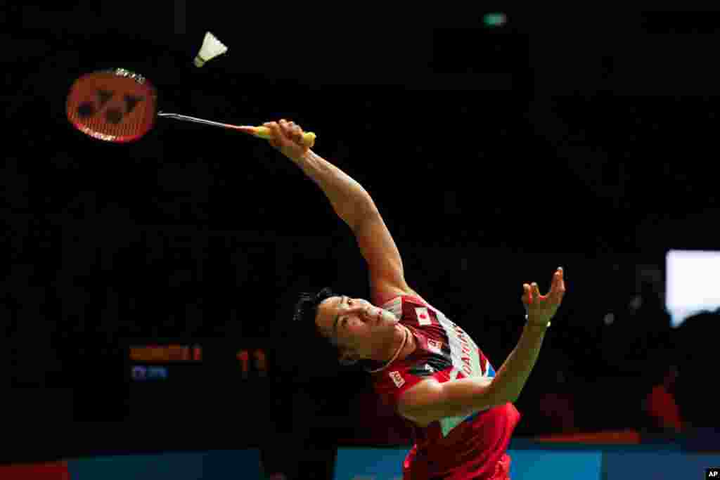 Japan&#39;s Kento Momota hits a return shot against China&#39;s Huang Yu Xiang during Malaysia Master men&#39;s single badminton quarterfinal in Kuala Lumpur, Malaysia.