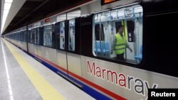An engineer performs a last check on a train that will travel through Marmaray tunnel, a subway that links Europe with Asia some 60 meters below the Bosphorus Strait, in Istanbul, Oct. 29, 2013.