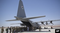 阿富汗国民军的军人2015年8月18日在阿富汗坎大哈空军基地排队进入C-130运输机。