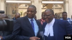 Tendai Biti, (R), opposition leader and member of Zimbabwe Lawyers for Human Rights, and Dzimbabwe Chibga from the rights group talk to reporters outside the High Court in Harare, Zimbabwe, September 2016. The two represented Zimbabwean opposition parties in court. (S. Mhofu/VOA)