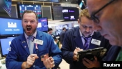 Traders work on the floor of the New York Stock Exchange shortly after the opening bell in New York, July 23, 2018. 