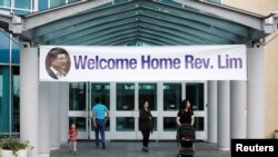 People walk under a welcome home sign for Pastor Hyeon Soo Lim, who returned to Canada from North Korea after the DPRK released Lim on August 9 after being held for 17 months, at the Light Presbyterian Church, in Mississauga, Ontario, Canada, Aug. 12, 201