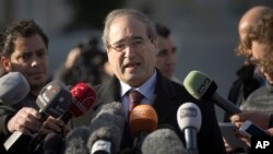 Syrian Deputy Foreign Minister Faisal Makdad answers journalists questions after a meeting with the Syrian opposition at the United Nations headquarters in Geneva, Switzerland, Jan. 28, 2014. 