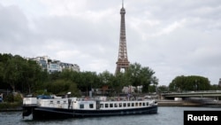 FILE - Boats rehearse on the River Seine in Paris on June 17, 2024, for the Olympics opening ceremony's floating parade on July 26.