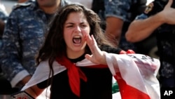 An anti-government school student shouts slogans, during ongoing protests against the Lebanese government in front the education ministry, in Beirut, Lebanon, Nov. 6, 2019.