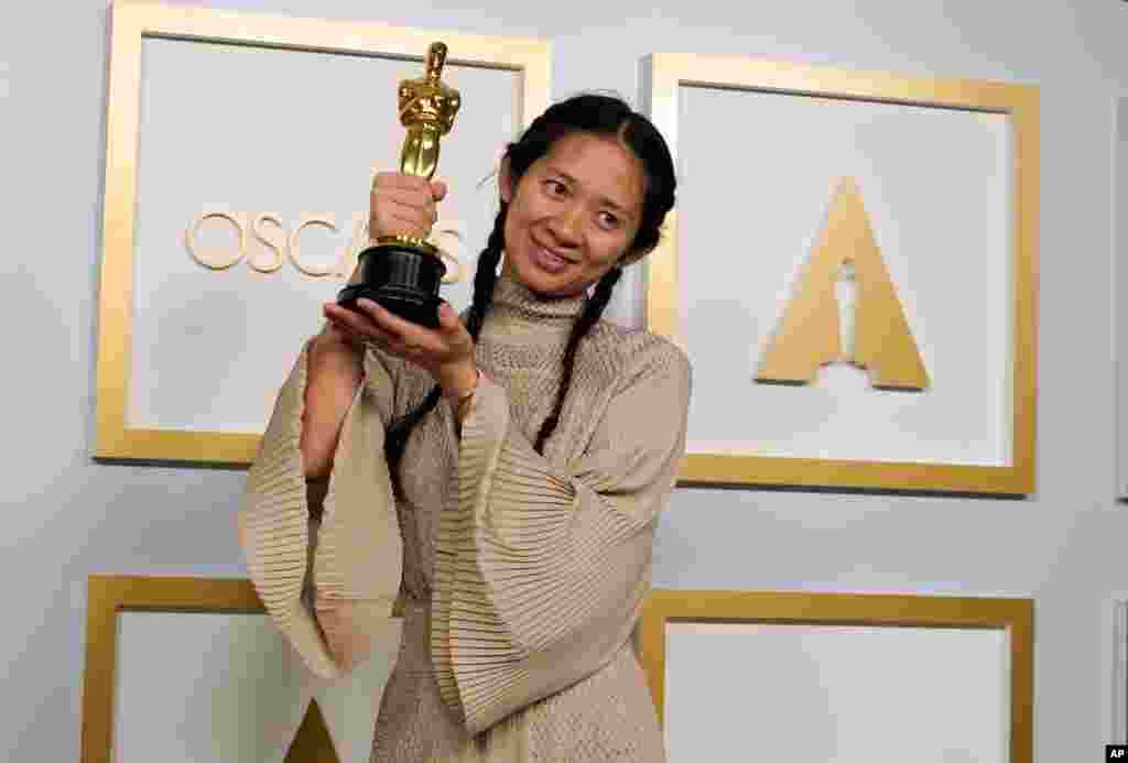 Director/Producer Chloe Zhao, winner of the award for best picture for &quot;Nomadland,&quot; poses in the press room at the Oscars on Sunday, April 25, 2021, at Union Station in Los Angeles. (AP Photo/Chris Pizzello, Pool)