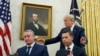 President Donald Trump, walks to acting Department of Homeland Security Secretary Kevin McAleenan, seated right, and Guatemalan Interior Minister Enrique Degenhart in the Oval Office of the White House, July 26, 2019. 