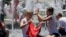 FILE - Children play in the fountain in the scorching heat in Melbourne, Australia, Jan. 16, 2014. 