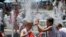 Children play in the fountain in the scorching heat at the Australian Open tennis championship in Melbourne, Australia, Thursday, Jan. 16, 2014. 