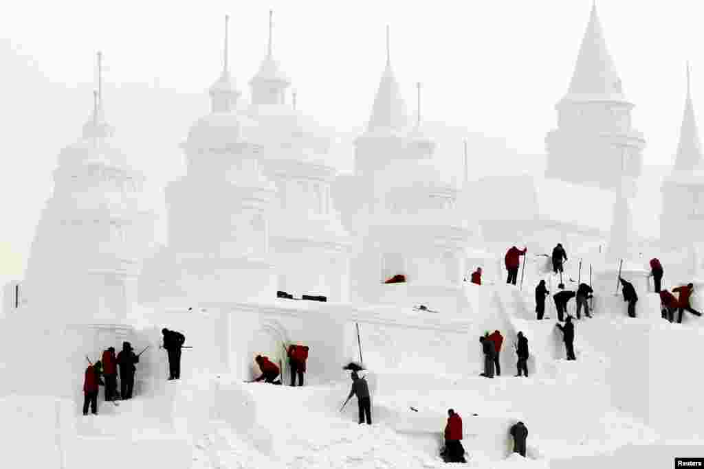 Para perajin membuat sebuah puri dari es di taman kota Changchun, provinsi Jilin, China.