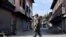 ndian security forces personnel stand guard in front of closed shops during restrictions imposed by authorities following the death of Syed Ali Shah Geelani, a Kashmiri veteran separatist politician, in Srinagar Sept. 3, 2021.