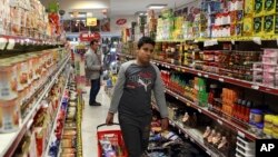 FILE - Iranians shop in a supermarket in north Tehran, April 2015.