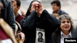 Human rights activists shout slogans at a memorial for Chile's deceased former president, Salvador Allende, whose democratically elected government was toppled in 1973 by General Augusto Pinochet, in Santiago, September 4, 2013.