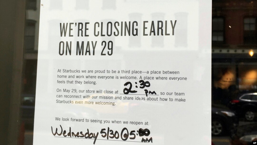 This May 27, 2018 photo shows a sign displayed at a Starbucks cafe in Portland, Maine, reminding customers that the store will be closed Tuesday for training.