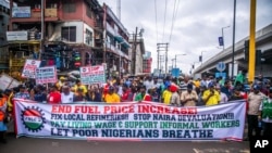 FILE - Labor unionists march in the streets of Lagos, Nigeria, Wednesday, Aug. 2, 2023, to protest the soaring cost of living under the West African nation's new president, with calls for the government to improve social welfare interventions to reduce hardship