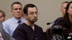 FILE - Larry Nassar sits during his sentencing hearing in Lansing, Mich. Nassar, a 54-year-old former doctor for USA Gymnastics and member of Michigan State's sports medicine staff, admitted to molesting athletes while he was supposedly treating them for 