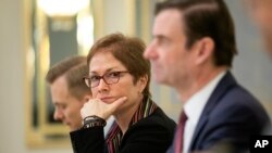FILE - Then-U.S. Ambassador to Ukraine Marie Yovanovitch, center, sits during a meeting in Kyiv, Ukraine, March 6, 2019.