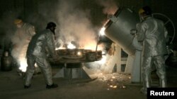 FILE - Technicians work at a uranium processing site in Isfahan, 340 km (211 miles) south of the Iranian capital, Tehran.