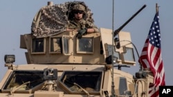 U.S. military convoy drives near the town of Qamishli, northen Syria, Oct. 26. 2019. Two successful raids by U.S.-led coalition in the oil-rich Deir el-Zour area were highlighted with the capture of a mid-level Islamic State leader.