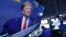 A television screen on the floor of the New York Stock Exchange shows President Donald Trump's speech to the Economic Club of New York, Nov. 12, 2019. 