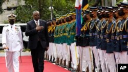 U.S. Defense Secretary Lloyd Austin, second from left, walks past military guards during his arrival at the Department of National Defense in Camp Aguinaldo military camp in Quezon City, Metro Manila, Philippines on Thursday February 2, 2023. 