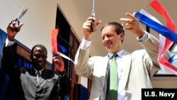 FILE - U.S. Ambassador to Tanzania, Mark Green, right, cuts a ribbon during a dedication ceremony at Jitegemee Secondary School in Dar es Salam, Tanzania, Dec. 18, 2008.