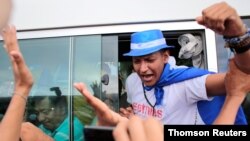 A political prisoner,who according to local media was arrested for participating in a protest against Nicaraguan President Daniel Ortega's government, shouts slogans after being released from La Modelo Prison, in Masaya, June 11, 2019.