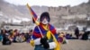 A youth with his face painted in the colors of the Tibetan flag takes part in a demonstration to mark Tibetan Women's Uprising Day to commemorate the 1959 revolt against Chinese occupation of Tibet, at the Polo Ground in Leh, on March 12, 2025.