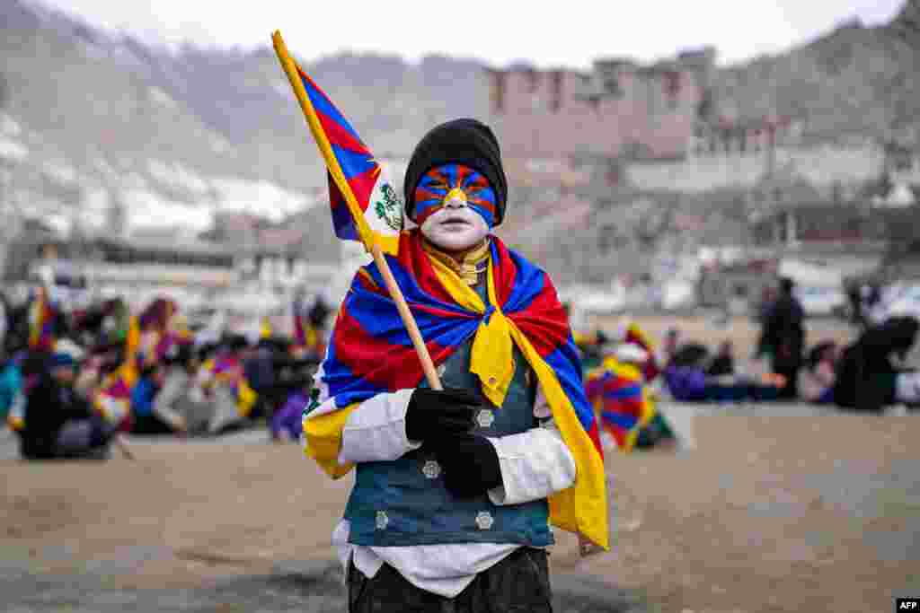 A youth with his face painted in the colors of the Tibetan flag takes part in a demonstration to mark Tibetan Women's Uprising Day to commemorate the 1959 revolt against Chinese occupation of Tibet, at the Polo Ground in Leh.